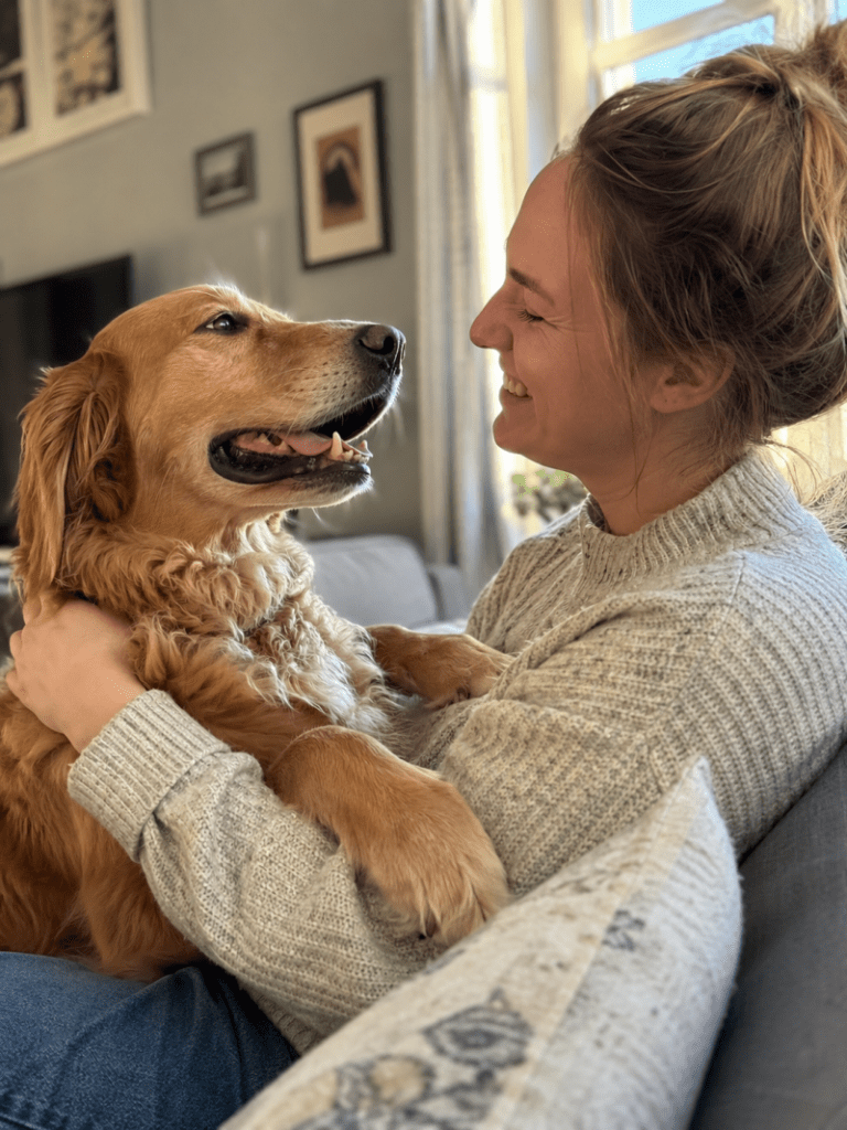 Dog and owner making eye contact during bonding moment, showing emotional connection and trust